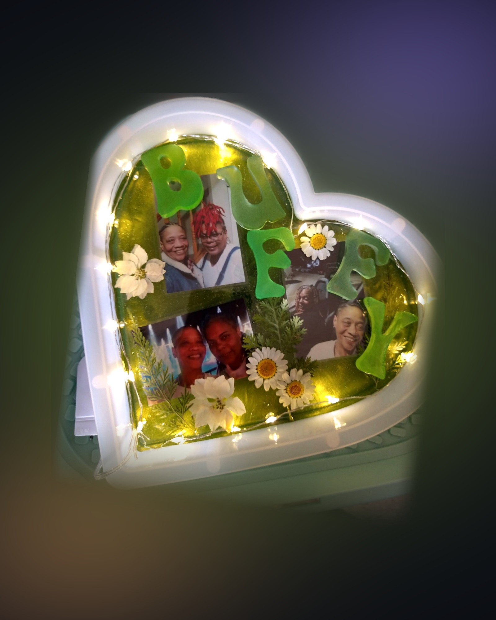 Heart-shaped resin keepsake with your photos, name letters, pressed daisies and fairy lights